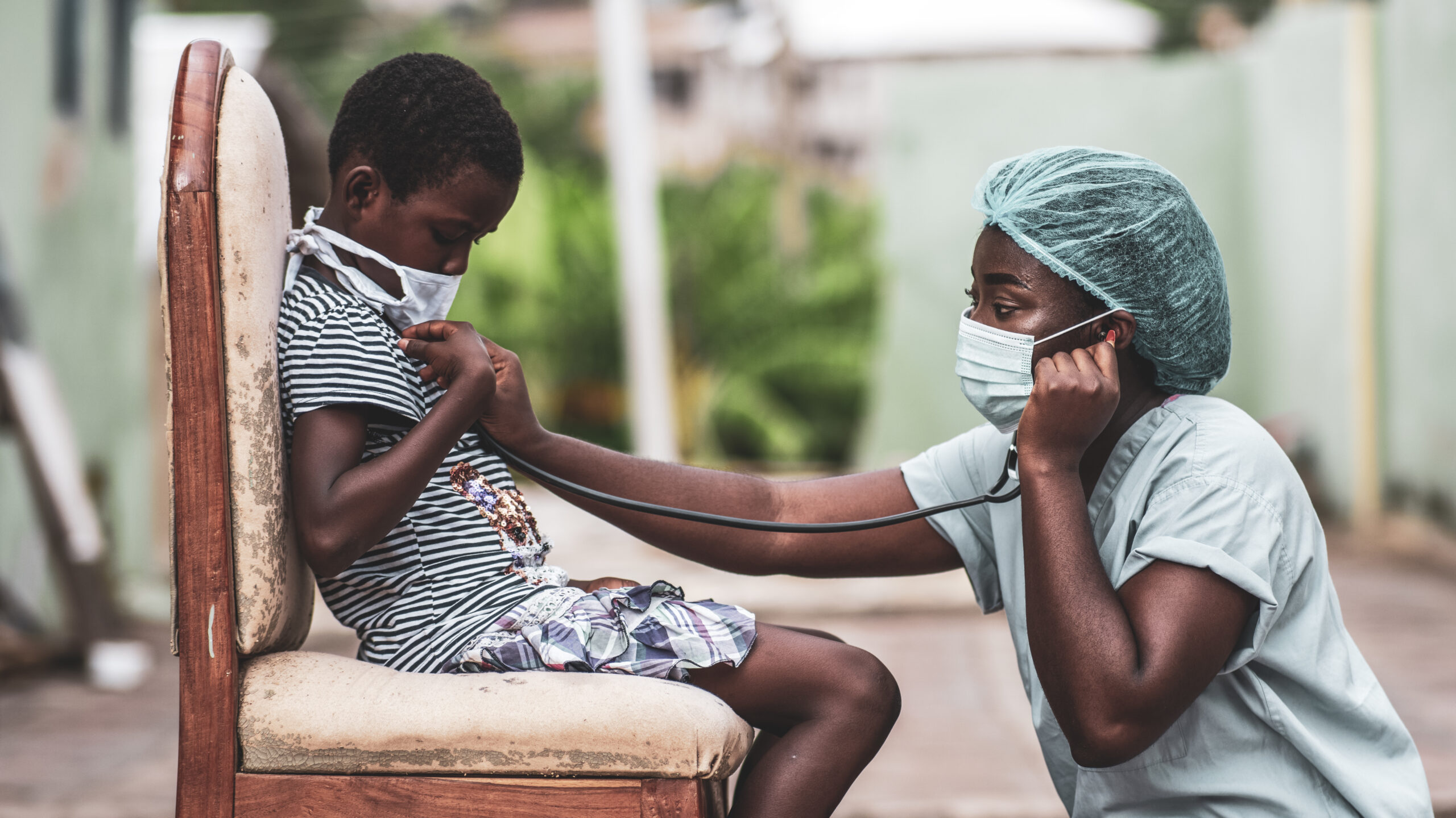 An African-American boy getting a checkup by a doctor